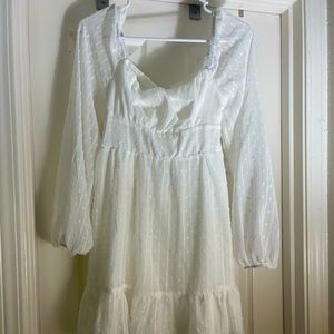 A beautiful tie back white long sleeve Swiss dot ruffle hem cami dress.